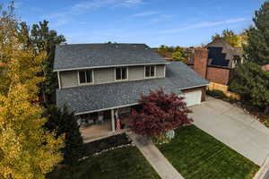 View of front of property featuring a garage and a front lawn