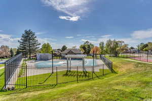 View of swimming pool featuring a lawn