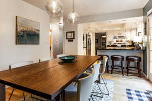 Dining area featuring light wood-type flooring and a tray ceiling