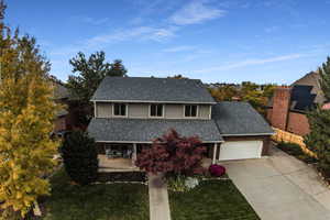 Front of property featuring a garage and a front yard