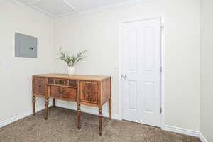 Interior space featuring electric panel and ornamental molding