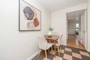 Dining room with dark hardwood / wood-style floors