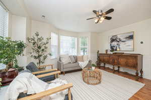 Living room featuring hardwood / wood-style flooring and ceiling fan