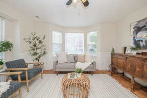 Living area featuring light wood-type flooring and ceiling fan