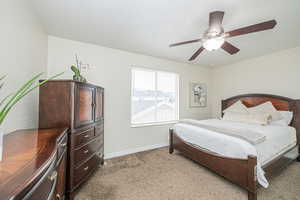 Bedroom featuring ceiling fan and carpet floors