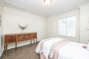 Bedroom with carpet and crown molding