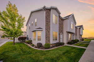 Property exterior at dusk featuring a yard