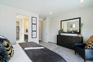 Carpeted bedroom with connected bathroom