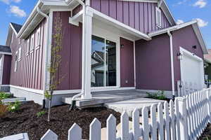 View of side of property featuring a garage and covered porch