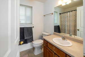 Master Bathroom featuring tile patterned flooring, vanity, and toilet