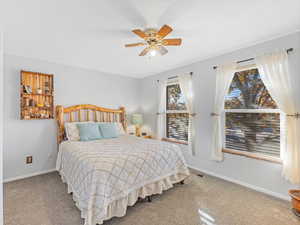 Carpeted bedroom with ceiling fan