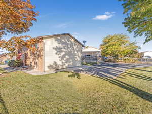 View of property exterior with a lawn