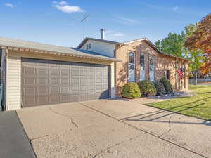 View of front of house with a front lawn and a garage