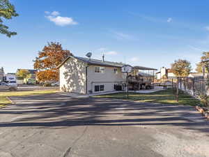 Rear view of house featuring a deck, central AC, and a yard