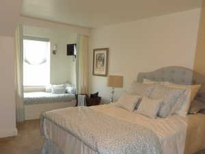 Bedroom featuring light carpet