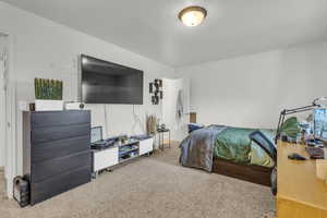 Carpeted bedroom featuring a textured ceiling