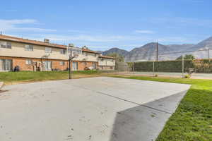 Surrounding community featuring a lawn and a mountain view