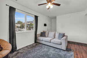 Living room featuring ceiling fan and hardwood / wood-style flooring