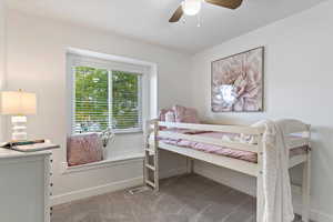 Bedroom with ceiling fan and carpet floors