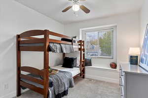 Carpeted bedroom with ceiling fan