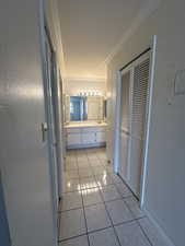 Primary Bathroom with vanity, tile patterned floors, and crown molding