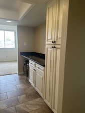 Kitchen featuring cream cabinetry and crown molding