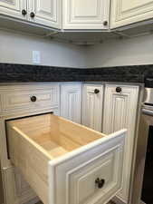 Interior details with white cabinets and stainless steel range