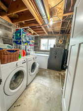 Clothes washing area featuring washer and dryer