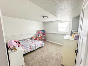 Carpeted bedroom with a textured ceiling