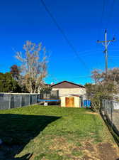 View of backyard with a trampoline and shed