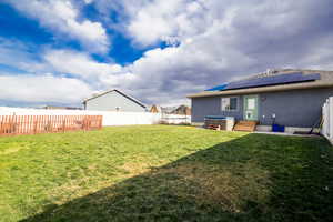 View of yard featuring cooling unit and a hot tub