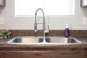 Room details with dark brown cabinetry and sink