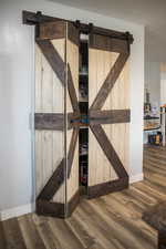 Room details with a barn door and wood-type flooring