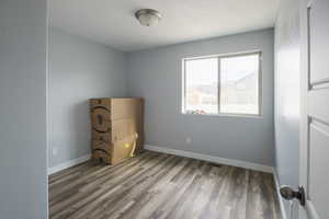 Unfurnished bedroom featuring wood-type flooring