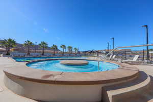 View of pool with a jacuzzi and a patio area