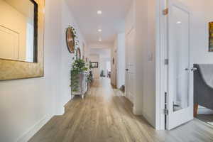 Corridor featuring wood-type flooring