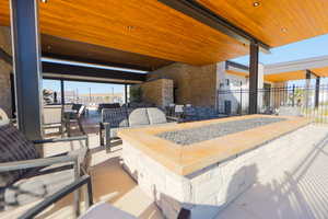 View of patio / terrace with an outdoor living space with a fire pit