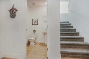 Stairs featuring wood-type flooring