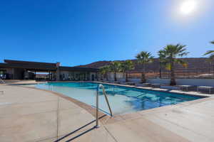 View of pool with a mountain view and a patio