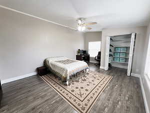 Bedroom with dark wood-type flooring and ceiling fan