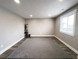 Empty room featuring dark hardwood / wood-style floors