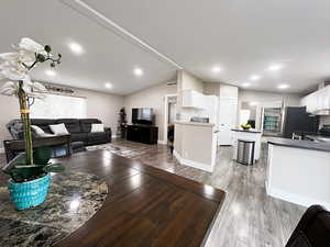 Living room featuring lofted ceiling and hardwood / wood-style flooring