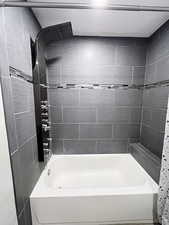 Bathroom with tiled shower / bath combo