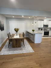 Dining area with light hardwood / wood-style flooring