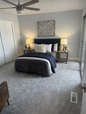 Bedroom with ceiling fan and carpet floors