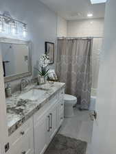 Full bathroom 2 featuring vanity, shower / bath combo with shower curtain, and toilet