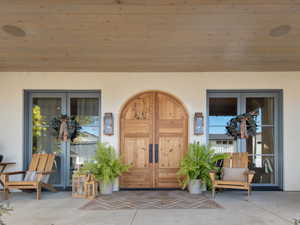 View of exterior entry featuring french doors and a patio