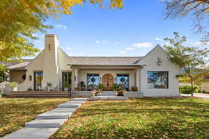 View of front facade featuring covered porch and a front lawn