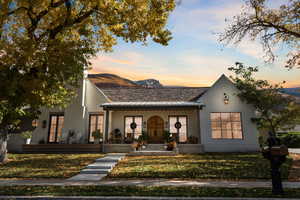 View of front of home featuring a mountain view and a porch