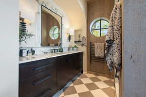 Bathroom with vanity and wood walls